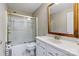 Bathroom featuring framed mirror, shower with glass door, tile flooring, and modern fixtures at 106 Zurich Ln, Statesville, NC 28625