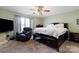 Comfortable bedroom with a ceiling fan, a large window, and neutral carpet at 106 Zurich Ln, Statesville, NC 28625