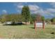 Community sign situated on a grassy lawn, surrounded by trees at 106 Zurich Ln, Statesville, NC 28625