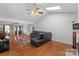 Bright living room with hardwood floors, a ceiling fan, and ample natural light from the skylight at 106 Zurich Ln, Statesville, NC 28625