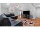 Bright living room featuring hardwood floors, skylights, and a cozy fireplace at 106 Zurich Ln, Statesville, NC 28625
