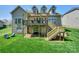 Large home exterior with deck, pergola, and well-maintained lawn at 10643 Rippling Stream Nw Dr, Concord, NC 28027