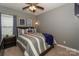 Cozy bedroom with a comfortable bed, stylish decor, and soft carpet at 10643 Rippling Stream Nw Dr, Concord, NC 28027