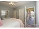 Bedroom featuring balcony access, soft carpet, and a comfortable queen-sized bed with stylish decor at 10643 Rippling Stream Nw Dr, Concord, NC 28027