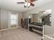 Spacious room with ping pong table, weights, large mirrors and neutral carpet at 10643 Rippling Stream Nw Dr, Concord, NC 28027