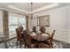 Formal dining room featuring a large window, wooden table with seating for six, and a decorative chandelier at 10643 Rippling Stream Nw Dr, Concord, NC 28027