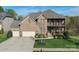 Charming brick home featuring a well-manicured lawn and inviting front porch and a three car garage at 10643 Rippling Stream Nw Dr, Concord, NC 28027