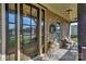 Inviting front porch featuring a decorative door, seasonal wreath and a comfortable seating area at 10643 Rippling Stream Nw Dr, Concord, NC 28027