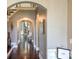 Welcoming foyer with hardwood floors leads to a cozy living area with a stone fireplace and staircase at 10643 Rippling Stream Nw Dr, Concord, NC 28027