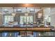 Open-concept kitchen with a marble island, stainless steel sink, and views of the dining and living areas at 10643 Rippling Stream Nw Dr, Concord, NC 28027