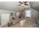 Relaxing living room area with a comfortable couch, natural light, and modern furnishings at 10643 Rippling Stream Nw Dr, Concord, NC 28027