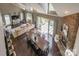 Aerial view of a bright living room with hardwood floors, a stone fireplace, and a view of the outdoor deck at 10643 Rippling Stream Nw Dr, Concord, NC 28027