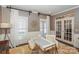 Bright home office with a modern desk, natural light, and elegant French doors at 10643 Rippling Stream Nw Dr, Concord, NC 28027