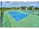Community tennis courts with well-maintained playing surfaces, nets, and fenced perimeter at 10643 Rippling Stream Nw Dr, Concord, NC 28027