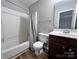 Simple bathroom features a shower with tub, new toilet and vanity at 11015 Harrowfield Rd, Charlotte, NC 28226