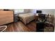 Bedroom with hardwood flooring, bright natural light, dresser and desk at 11015 Harrowfield Rd, Charlotte, NC 28226