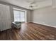Cozy bedroom with a large window and chair, complete with wood floors at 11015 Harrowfield Rd, Charlotte, NC 28226