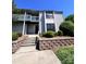 A charming condominium building with a second story balcony and landscaped entrance at 11015 Harrowfield Rd, Charlotte, NC 28226