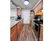 Functional kitchen with stainless steel appliances, light wood cabinets and durable wood floors at 11015 Harrowfield Rd, Charlotte, NC 28226