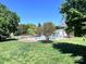Community pool surrounded by trees, lounge chairs, and a fenced perimeter at 11015 Harrowfield Rd, Charlotte, NC 28226