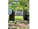 The community signage displays the neighborhood name with an established look surrounded by lush landscaping at 11015 Harrowfield Rd, Charlotte, NC 28226