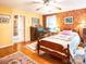 Bright bedroom featuring hardwood floors, floral wallpaper accent wall, and comfortable furnishings at 1213 10Th Street Nw Ln # 3, Hickory, NC 28601