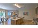 Open-concept kitchen with granite countertops, stainless steel appliances, and a view of the dining and living areas at 127 Way Cross Ln, Troutman, NC 28166