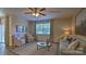 Bright and airy living room with ceiling fan, large window, and stylish decor at 127 Way Cross Ln, Troutman, NC 28166