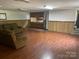 Expansive finished basement featuring a wet bar, living area, and wood-look flooring, ideal for gatherings at 1300 Irish Potato Rd, Concord, NC 28025