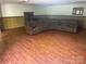 Spacious finished basement with a large seating area and wood-look flooring, great for entertaining at 1300 Irish Potato Rd, Concord, NC 28025