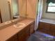 Bright bathroom featuring a vanity with a sink and a separate bathtub at 1300 Irish Potato Rd, Concord, NC 28025