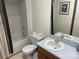 Cozy bathroom features a vanity, toilet, tub/shower combo with decorative curtain, and tile flooring at 1300 Irish Potato Rd, Concord, NC 28025