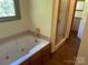 Bathroom boasting a large jacuzzi tub and a separate glass shower at 1300 Irish Potato Rd, Concord, NC 28025