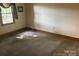 Neutral carpeted bedroom with bright, natural light from a large window at 1300 Irish Potato Rd, Concord, NC 28025