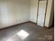 Cozy bedroom featuring neutral carpet, wood trim, and a closet at 1300 Irish Potato Rd, Concord, NC 28025