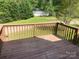 Wood deck overlooks a serene yard with a separate garage, perfect for outdoor enjoyment and storage solutions at 1300 Irish Potato Rd, Concord, NC 28025