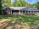 Brick home with a cozy front porch and manicured landscaping, creating a warm curb appeal at 1300 Irish Potato Rd, Concord, NC 28025