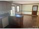 Kitchen with wood cabinets, laminate countertops, hardwood floors, and access to the backyard at 1300 Irish Potato Rd, Concord, NC 28025