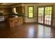 Spacious kitchen features hardwood floors, appliances, breakfast bar, and access to the outdoors at 1300 Irish Potato Rd, Concord, NC 28025
