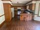 Traditional kitchen with wood cabinets, appliances, breakfast bar, and hardwood floors at 1300 Irish Potato Rd, Concord, NC 28025