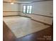Spacious living room with neutral carpet, wood trim and baseboards, and lots of natural light at 1300 Irish Potato Rd, Concord, NC 28025