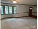 Bright living room with neutral carpet, wood trim, and multiple windows providing natural light at 1300 Irish Potato Rd, Concord, NC 28025