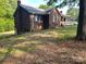 Brick home with lush green lawn extending to the side and a glimpse of the front porch at 1300 Irish Potato Rd, Concord, NC 28025