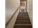 Carpeted stairway leading up with a wood handrail at 1300 Irish Potato Rd, Concord, NC 28025