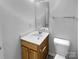 Bathroom featuring a wood vanity, white countertops, mirror, and toilet at 1325 Crandon Dr, Charlotte, NC 28216