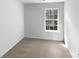 Bright bedroom features neutral carpet, one window, and ample space at 1325 Crandon Dr, Charlotte, NC 28216