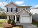 Charming two-story home with a one car garage, gray siding, and black shutters at 1325 Crandon Dr, Charlotte, NC 28216