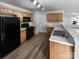 Kitchen with stainless steel appliances, wood cabinets, laminate countertops, and luxury vinyl plank flooring at 1325 Crandon Dr, Charlotte, NC 28216