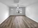 Spacious living room with a ceiling fan, luxury vinyl plank flooring, and ample natural light at 1325 Crandon Dr, Charlotte, NC 28216