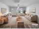 Living room virtually staged, featuring neutral paint, recessed lighting, ceiling fan and luxury vinyl plank flooring at 1325 Crandon Dr, Charlotte, NC 28216